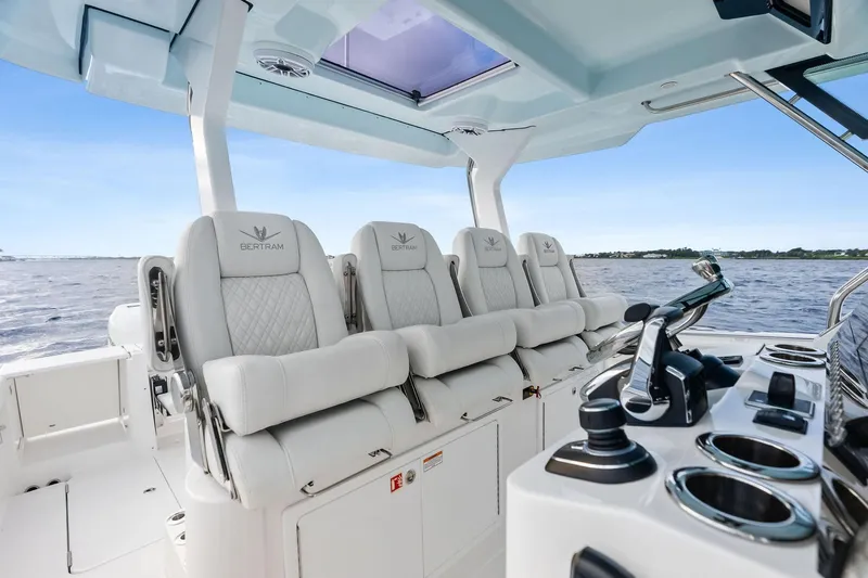 Isla Yacht Photos Pics 2022 Bertram 39 CC boat interior with luxurious seating and modern controls.