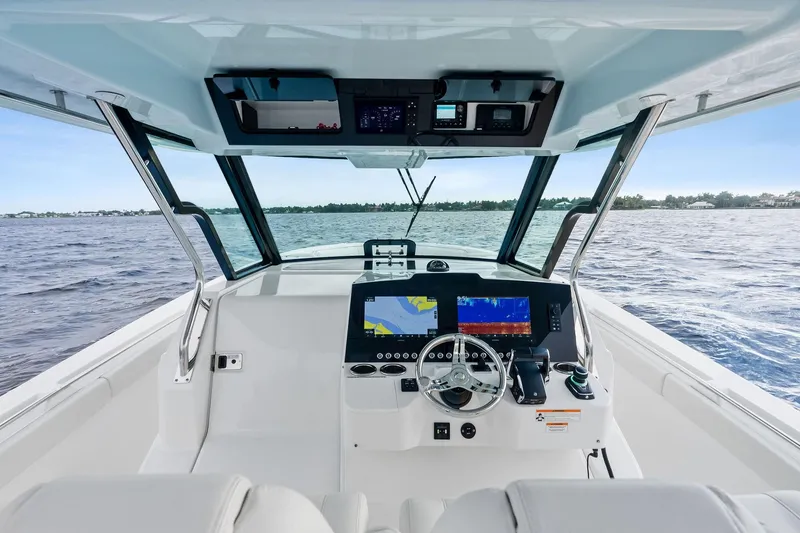 Isla Yacht Photos Pics 2022 Bertram 39 CC boat cockpit with advanced navigation systems on open water.