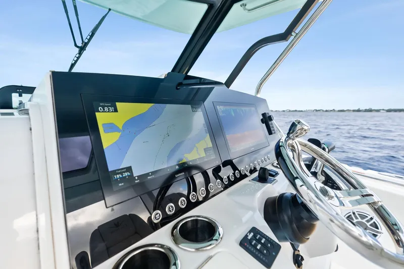 Isla Yacht Photos Pics Bertram 39 CC 2022 boat dashboard with navigation screens and steering wheel.