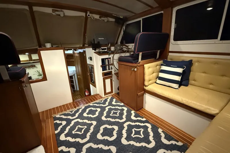 Oasis Yacht Photos Pics Luxurious interior of 1987 Wilbur 38 yacht with elegant seating and nautical decor.