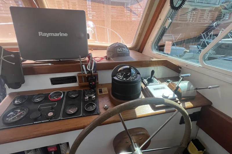 Oasis Yacht Photos Pics Helm of 1987 Wilbur 38 boat with Raymarine equipment and navigational controls.