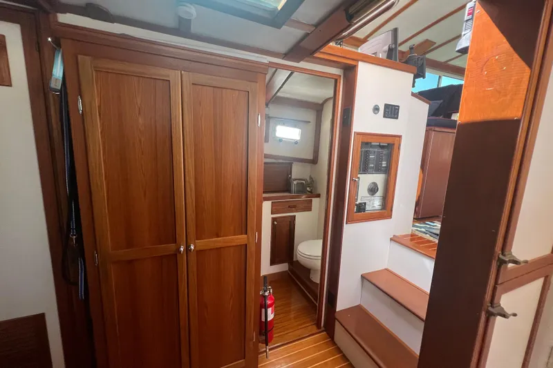 Oasis Yacht Photos Pics Interior of 1987 Wilbur 38 boat with wooden cabinetry and compact bathroom.