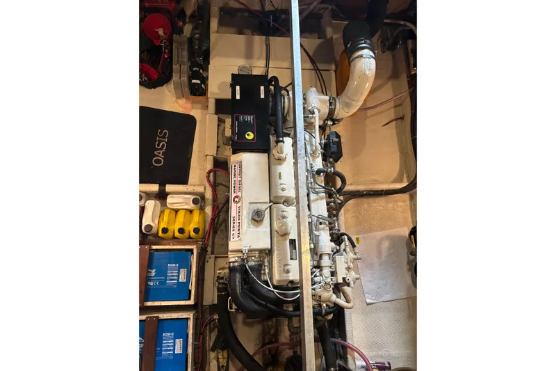 Oasis Yacht Photos Pics Engine room of a 1987 Wilbur 38 boat, showcasing mechanical components and wiring.