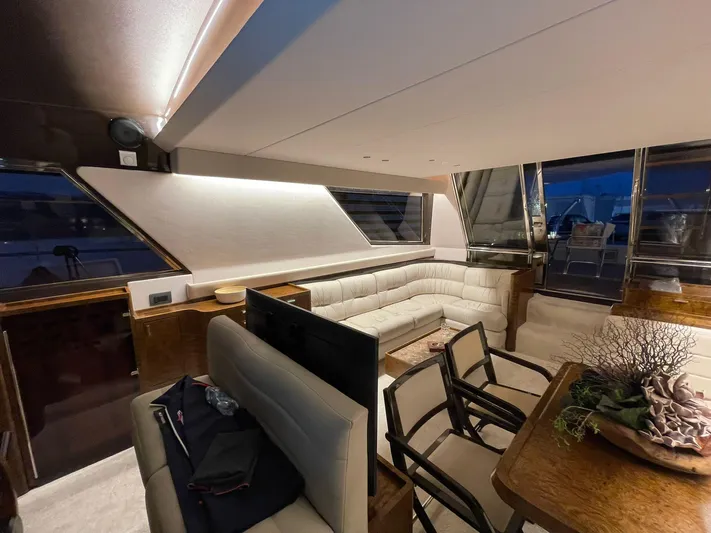  Yacht Photos Pics Luxurious interior of a 1990 Riva Corsaro 20 yacht with elegant seating and dining area.