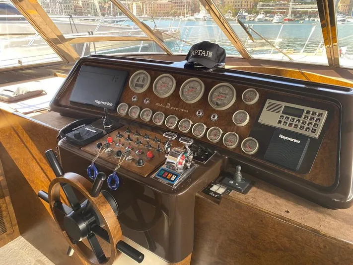  Yacht Photos Pics Helm of 1990 Riva Corsaro 20 yacht with gauges, controls, and captain's hat.