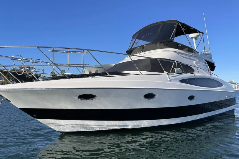  Yacht Photos Pics 2006 Regal Commodore 3880 yacht on water, sleek design, clear blue sky background.