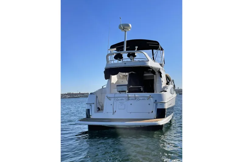  Yacht Photos Pics 2006 Regal Commodore 3880 yacht on calm water, rear view, sunny day.