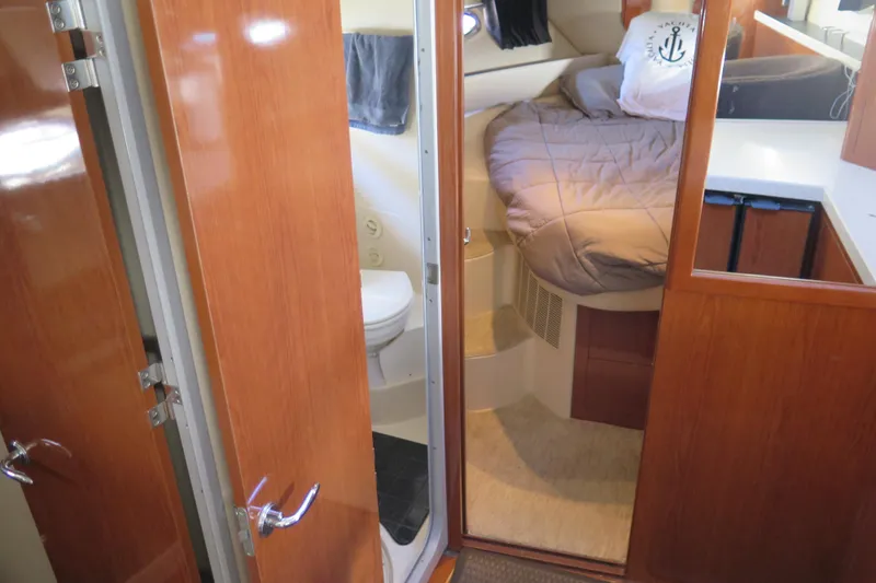 Yacht Photos Pics 2006 Regal Commodore 3880 yacht interior with cozy bedroom and bathroom.