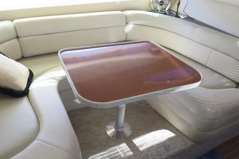  Yacht Photos Pics Luxurious interior of 2006 Regal Commodore 3880 yacht with elegant seating and wooden table.