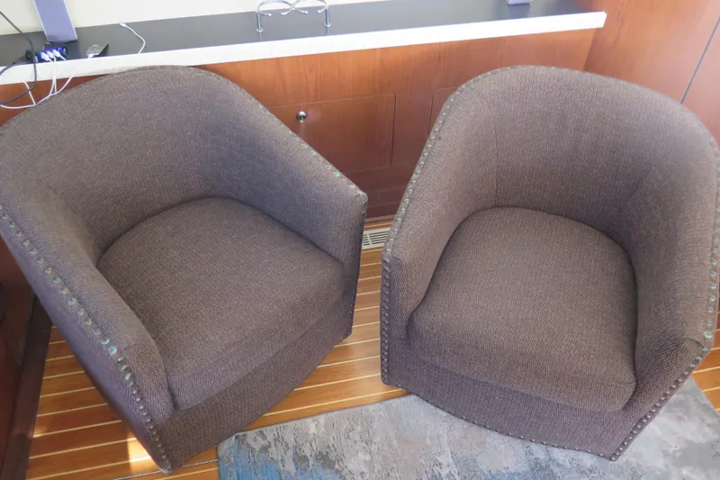  Yacht Photos Pics Two brown upholstered chairs on a Regal Commodore 3880 yacht, 2006 model.