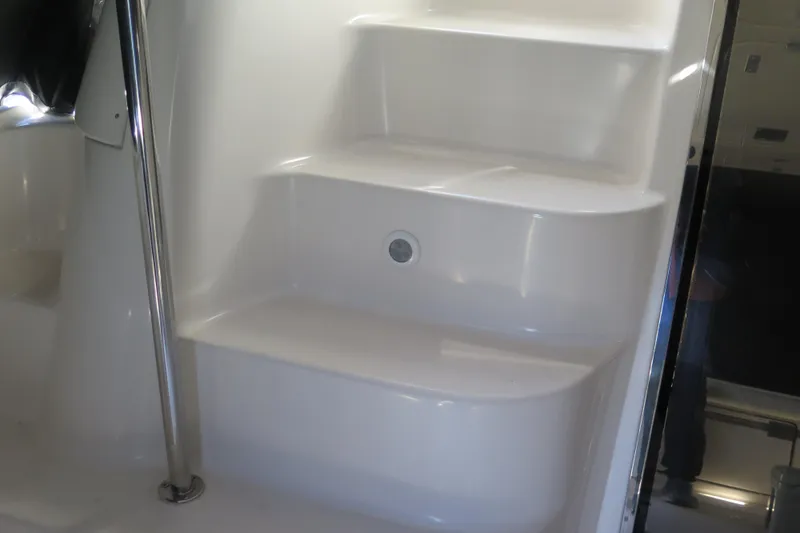  Yacht Photos Pics Interior steps of 2006 Regal Commodore 3880 yacht, featuring sleek white design and metal railing.