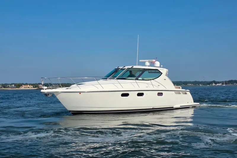 Living Benefit Yacht Photos Pics 2007 Tiara Yachts 3900 Sovran cruising on open water under clear blue sky.