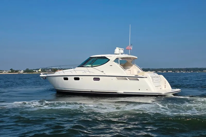 Living Benefit Yacht Photos Pics 2007 Tiara Yachts 3900 Sovran cruising on open water under clear blue skies.