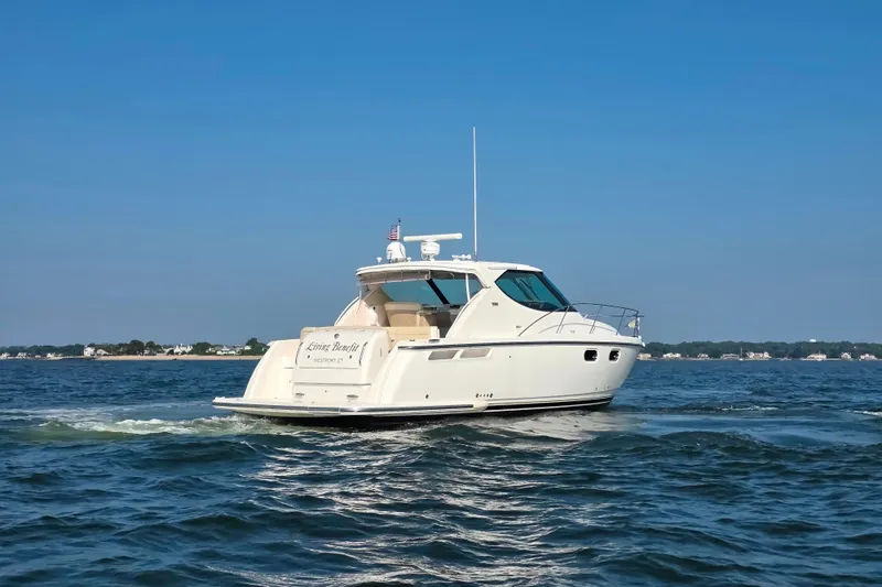 Living Benefit Yacht Photos Pics 2007 Tiara Yachts 3900 Sovran cruising on open water under clear blue skies.