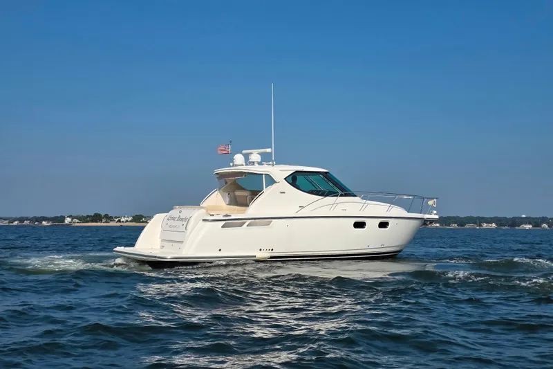 Living Benefit Yacht Photos Pics 2007 Tiara Yachts 3900 Sovran cruising on open water under clear blue sky.