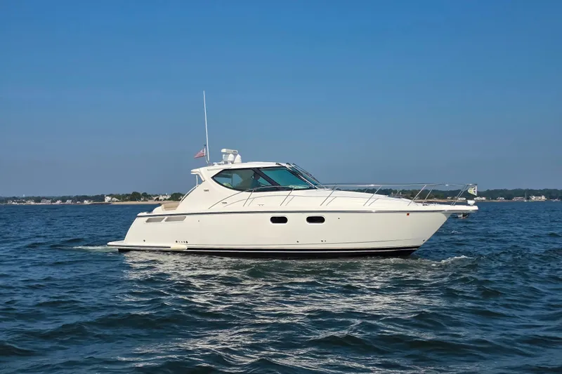 Living Benefit Yacht Photos Pics 2007 Tiara Yachts 3900 Sovran cruising on open water under clear blue skies.