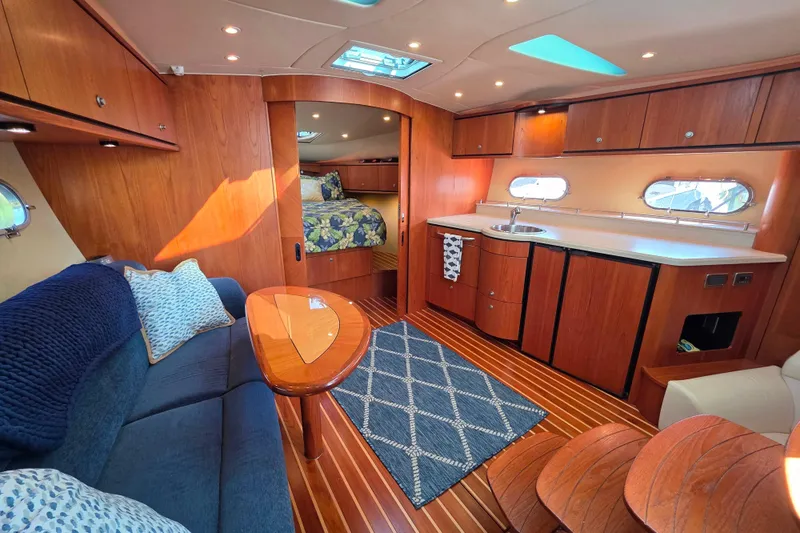 Living Benefit Yacht Photos Pics Luxurious interior of 2007 Tiara Yachts 3900 Sovran with wood finish and cozy seating.