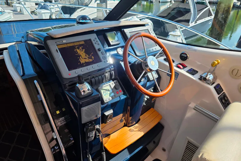 Living Benefit Yacht Photos Pics 2007 Tiara Yachts 3900 Sovran helm with navigation equipment and wooden steering wheel.