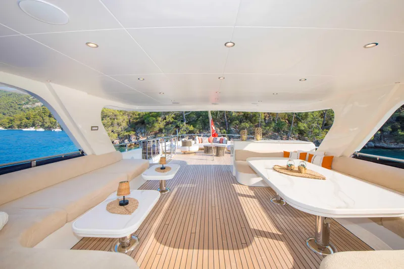 Ns02282 Yacht Photos Pics Luxurious 2023 Custom Motorsailer 41M deck with elegant seating and scenic ocean view.