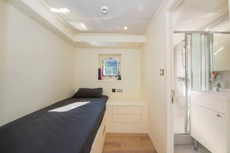 Ns02282 Yacht Photos Pics 2023 Custom Motorsailer 41M cabin with single bed, window, and ensuite bathroom.