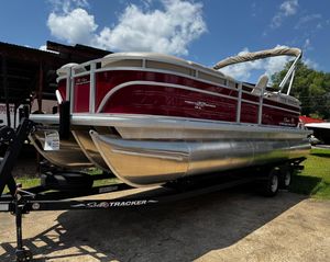 2024 Sun Tracker Party Barge 22 XP3 pontoon boat on trailer under blue sky.