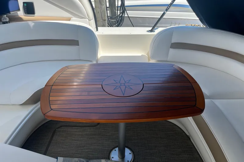Lilley Pad Yacht Photos Pics Luxurious 2007 Sea Ray 44 Sundancer yacht interior with elegant wooden table and plush seating.