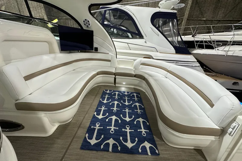 Lilley Pad Yacht Photos Pics Luxurious 2007 Sea Ray 44 Sundancer yacht interior with white seating and anchor-themed rug.