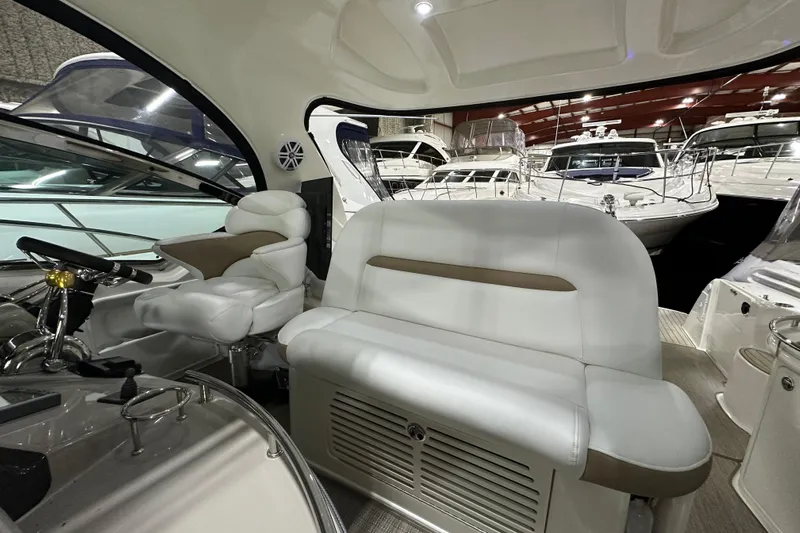 Lilley Pad Yacht Photos Pics Interior of 2007 Sea Ray 44 Sundancer yacht with white seating and helm station.