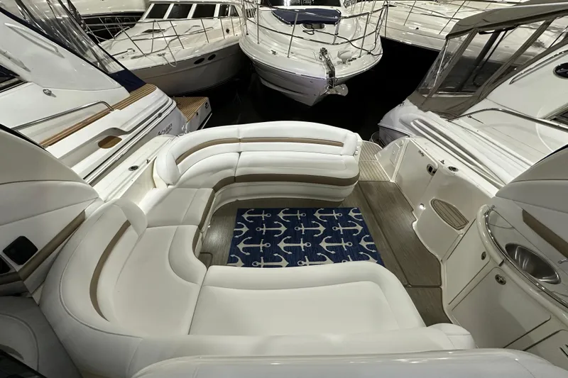 Lilley Pad Yacht Photos Pics Luxurious 2007 Sea Ray 44 Sundancer yacht interior with white seating and nautical-themed rug.
