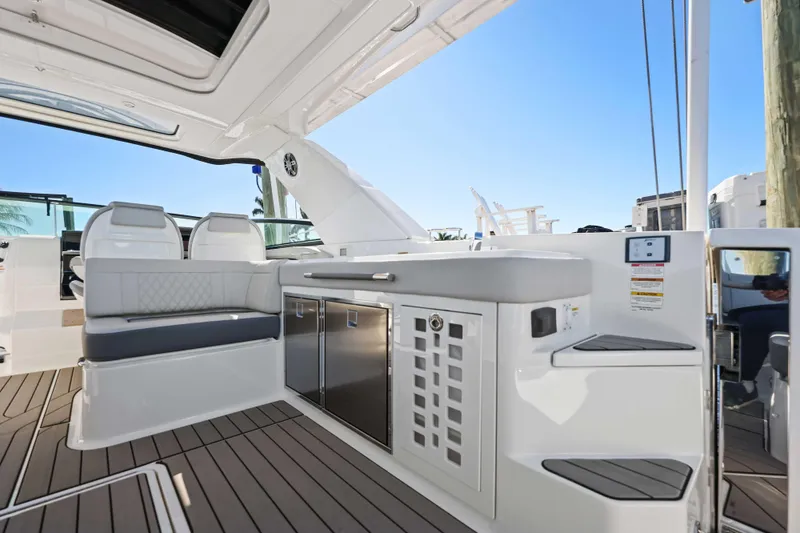  Yacht Photos Pics 2023 Sea Ray SLX 400 Outboard interior with seating and cabinetry, showcasing luxury design.