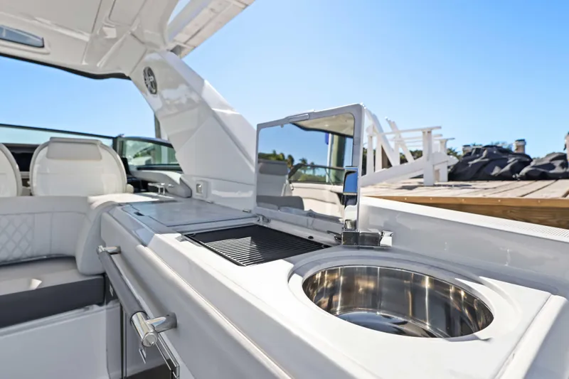  Yacht Photos Pics 2023 Sea Ray SLX 400 Outboard boat interior with sink and seating area.