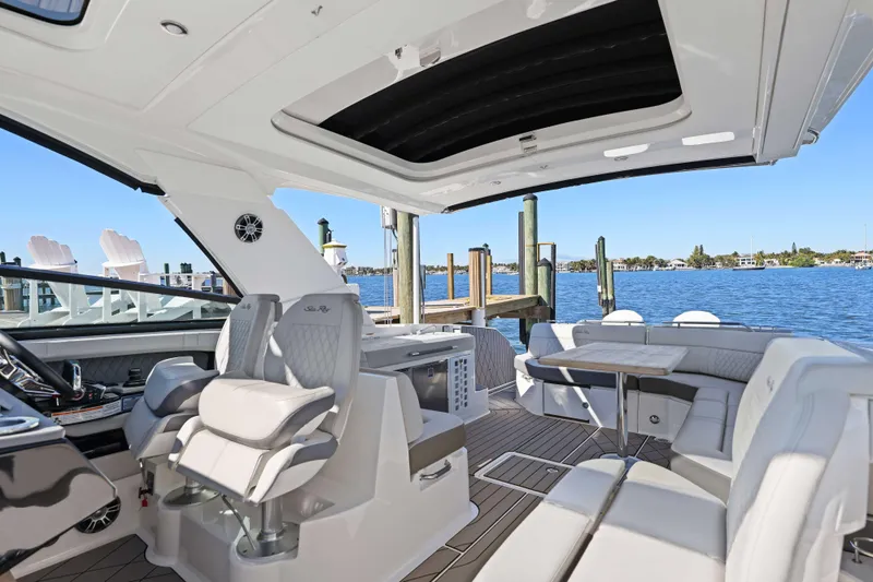  Yacht Photos Pics Luxurious 2023 Sea Ray SLX 400 Outboard interior with plush seating and scenic waterfront view.