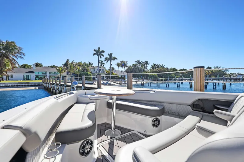  Yacht Photos Pics 2023 Sea Ray SLX 400 Outboard boat interior with waterfront view and palm trees.
