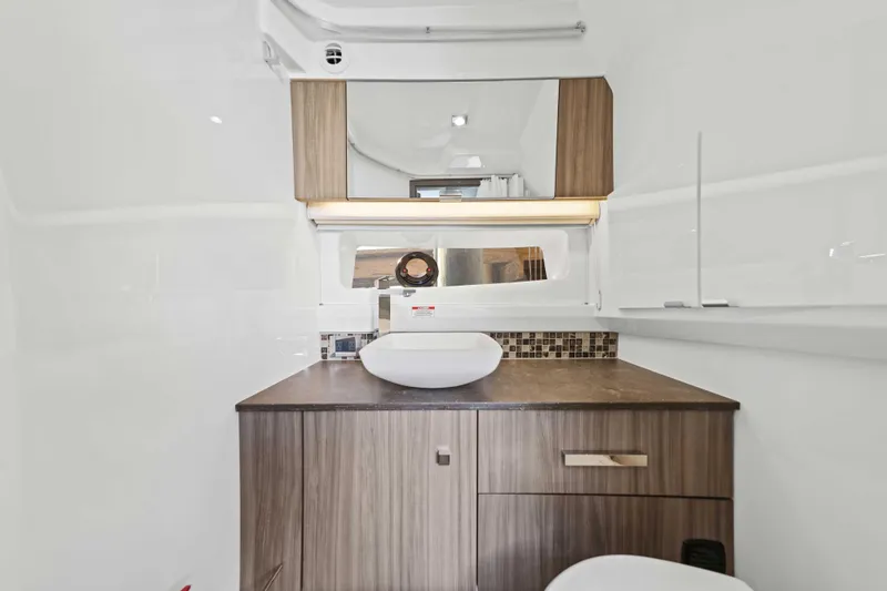  Yacht Photos Pics Luxurious bathroom interior of 2023 Sea Ray SLX 400 Outboard yacht, featuring modern sink and cabinetry.