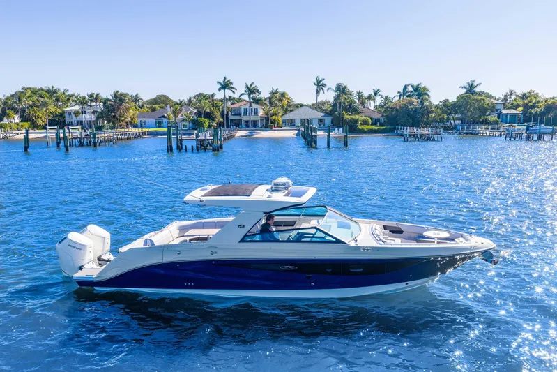  Yacht Photos Pics 2023 Sea Ray SLX 400 Outboard cruising on a sunny, blue waterway.