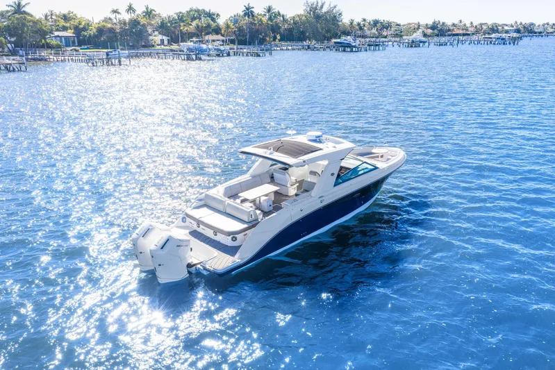  Yacht Photos Pics 2023 Sea Ray SLX 400 Outboard cruising on sparkling blue water.