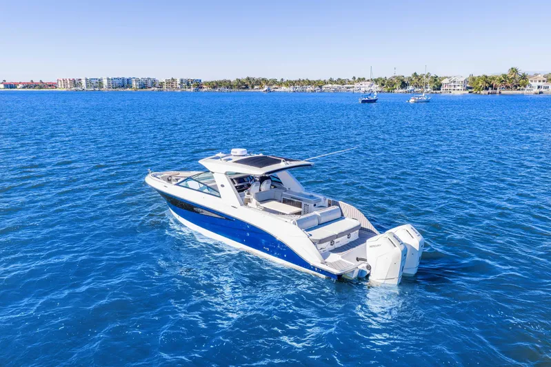 Yacht Photos Pics 2023 Sea Ray SLX 400 Outboard cruising on clear blue water.