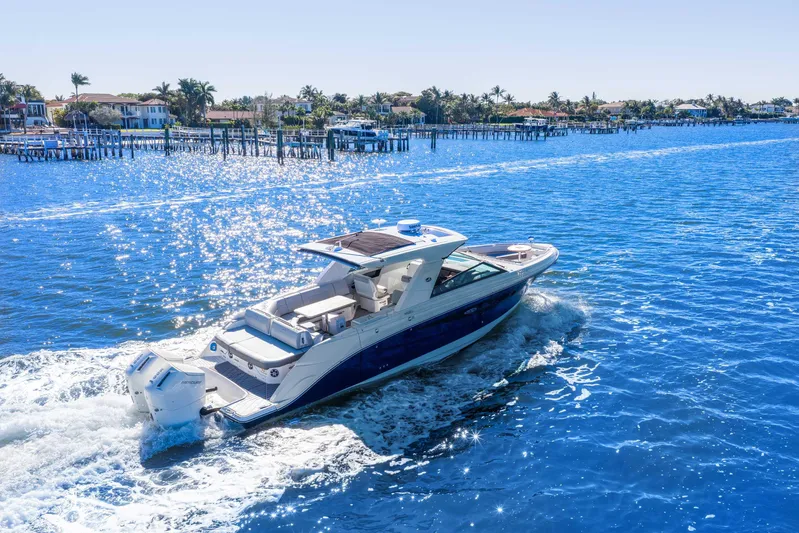  Yacht Photos Pics 2023 Sea Ray SLX 400 Outboard cruising on a sunny, sparkling blue waterway.