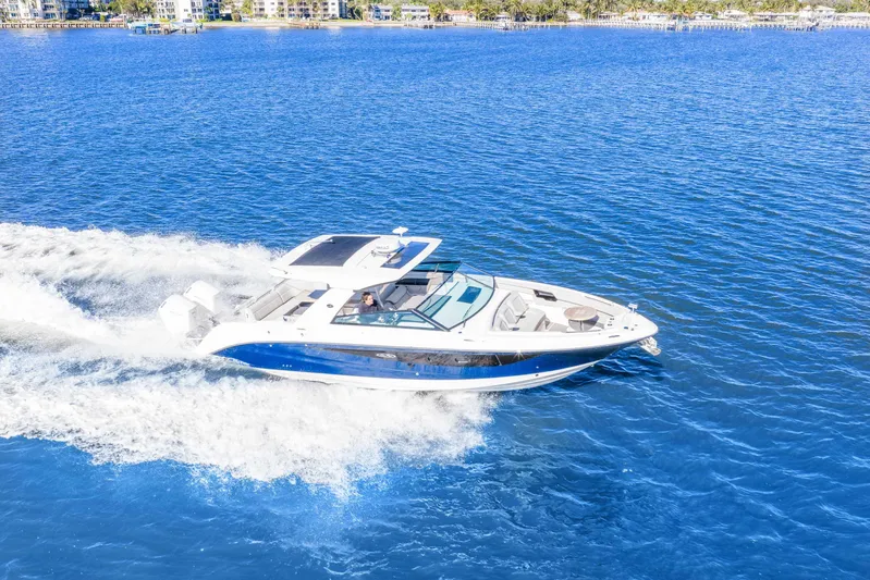  Yacht Photos Pics 2023 Sea Ray SLX 400 Outboard cruising on blue ocean waters.