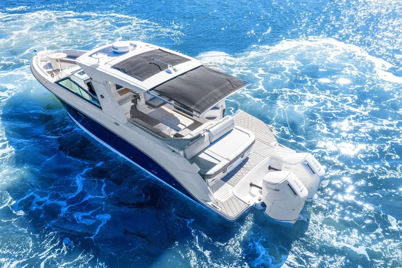  Yacht Photos Pics 2023 Sea Ray SLX 400 Outboard cruising on sparkling blue ocean waters.