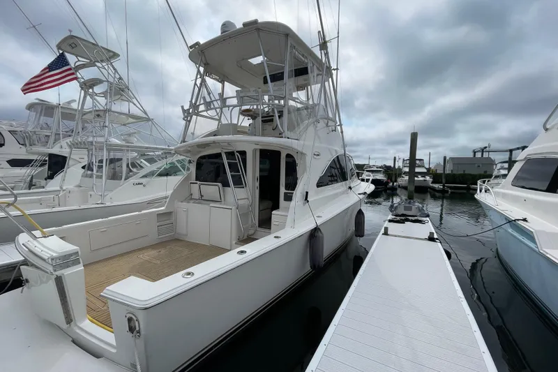 Reel It In Yacht Photos Pics 2003 Ocean Yachts 40 Super Sport docked at marina under cloudy sky.