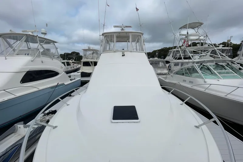 Reel It In Yacht Photos Pics 2003 Ocean Yachts 40 Super Sport docked among other boats under cloudy skies.