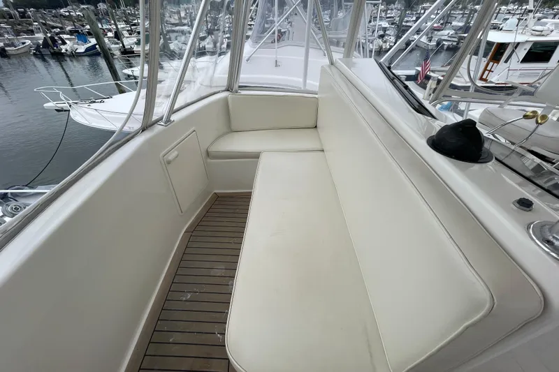 Reel It In Yacht Photos Pics 2003 Ocean Yachts 40 Super Sport boat interior with white seating and wooden flooring.