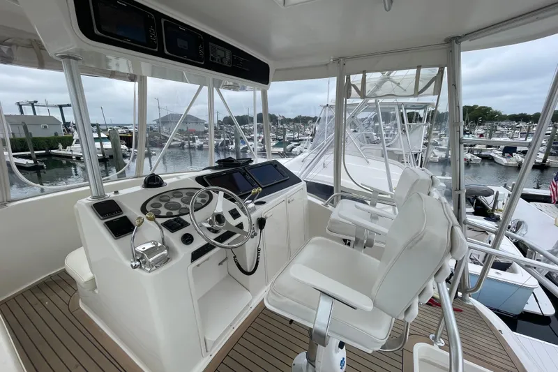 Reel It In Yacht Photos Pics 2003 Ocean Yachts 40 Super Sport helm with dual seats, marina view in background.