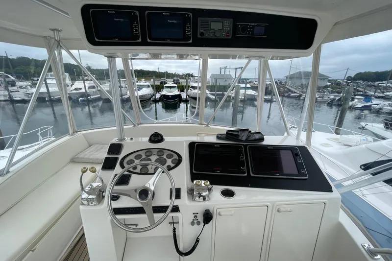 Reel It In Yacht Photos Pics Helm of 2003 Ocean Yachts 40 Super Sport, featuring advanced navigation equipment and marina view.