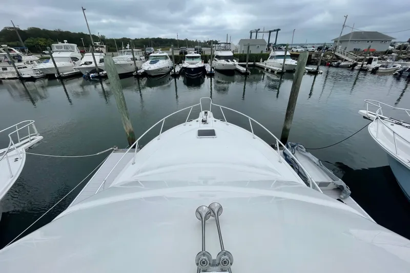 Reel It In Yacht Photos Pics 2003 Ocean Yachts 40 Super Sport docked in a marina with other boats.