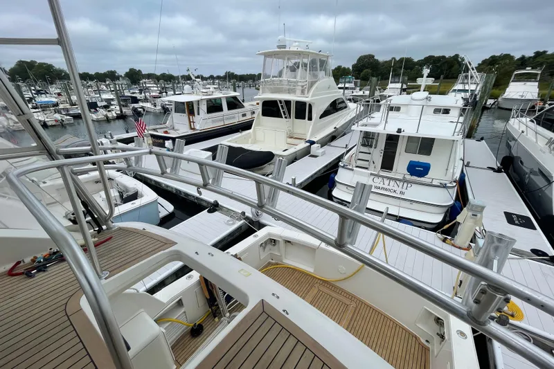 Reel It In Yacht Photos Pics Marina view with Ocean Yachts 40 Super Sport, 2003 model, docked among other boats.