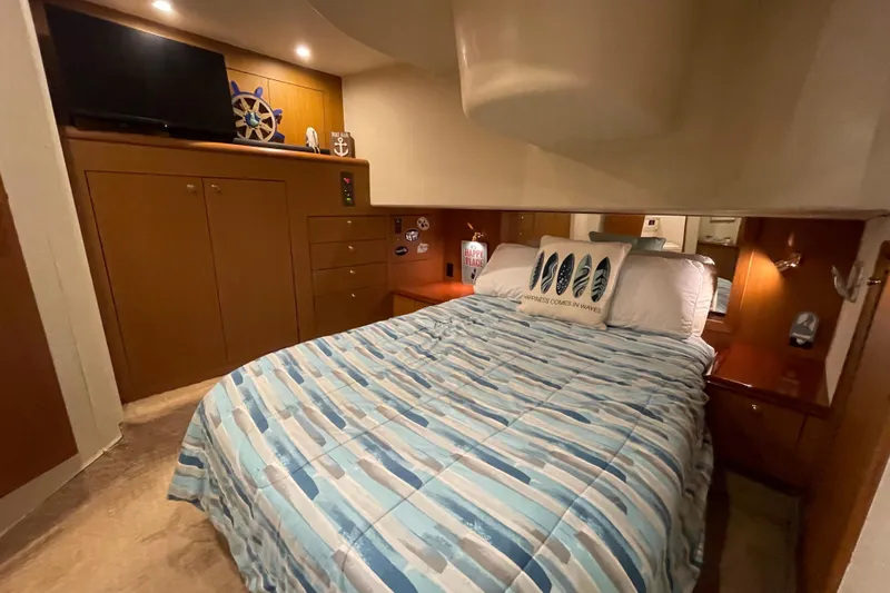 Reel It In Yacht Photos Pics Cozy bedroom in 2003 Ocean Yachts 40 Super Sport with nautical decor and striped bedding.