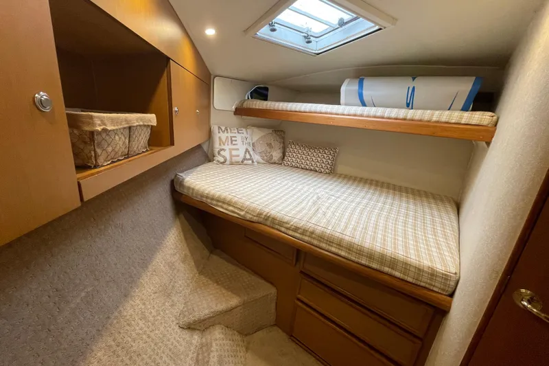 Reel It In Yacht Photos Pics Cozy cabin interior of 2003 Ocean Yachts 40 Super Sport with bunk beds and storage.