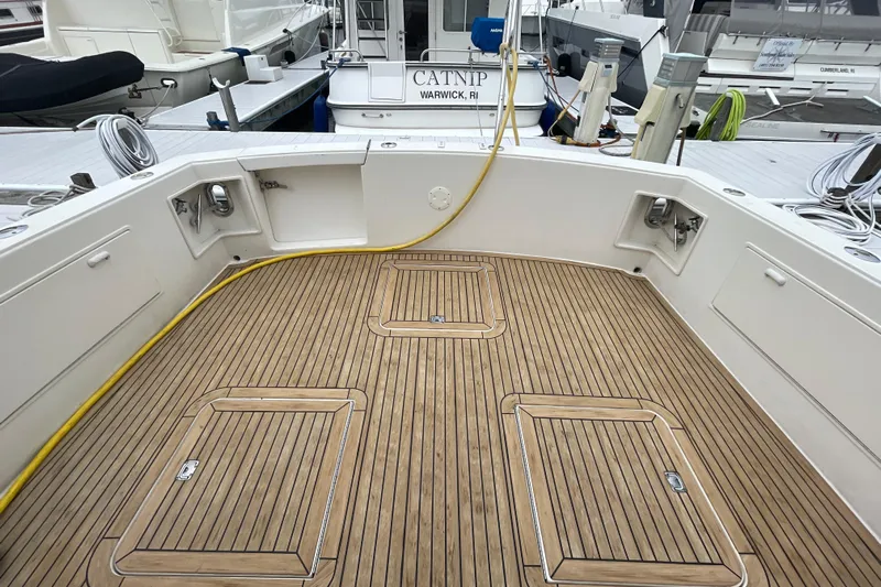 Reel It In Yacht Photos Pics 2003 Ocean Yachts 40 Super Sport boat deck with teak flooring at a marina.